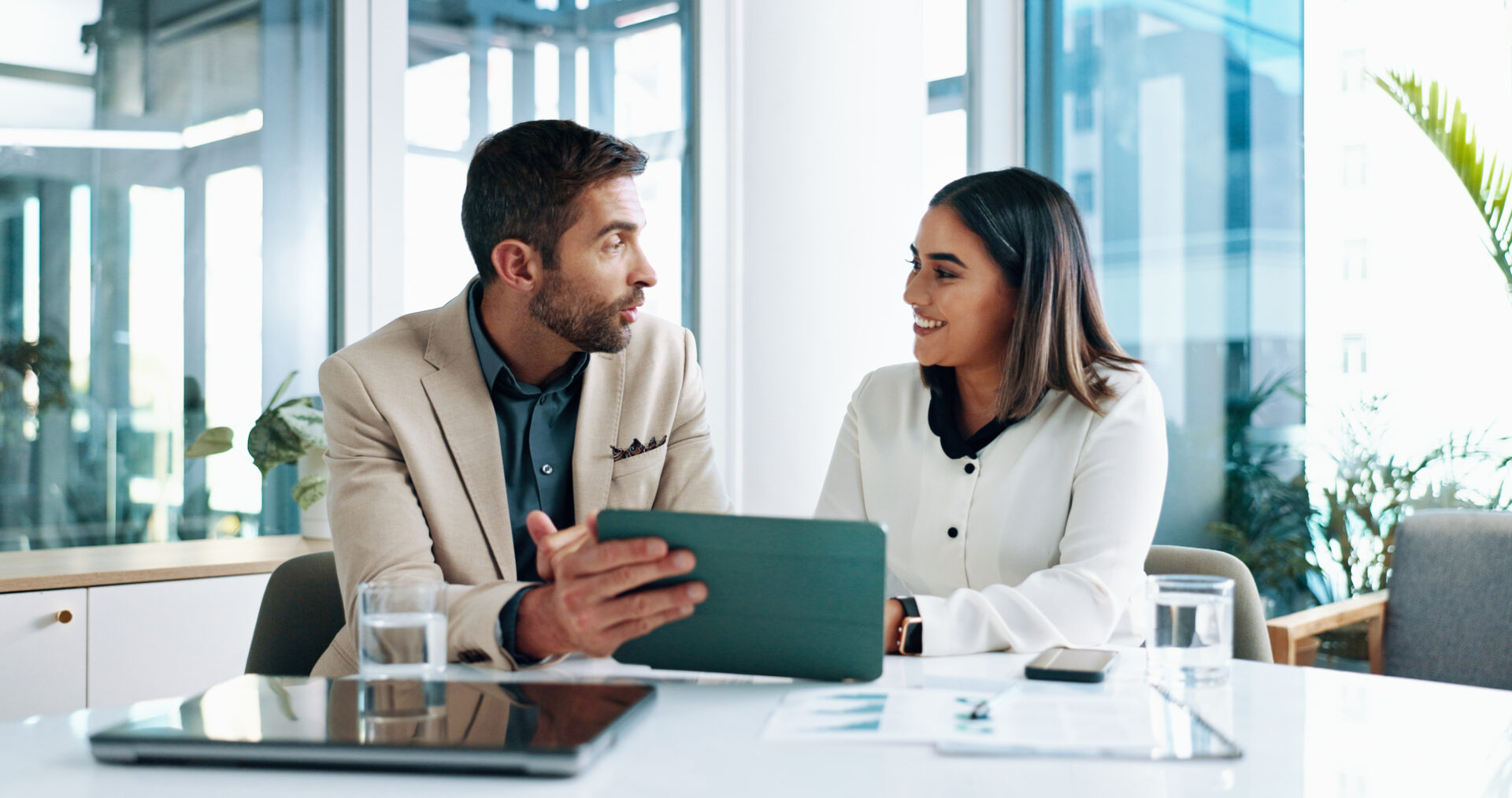 Colleagues discussing work at office table