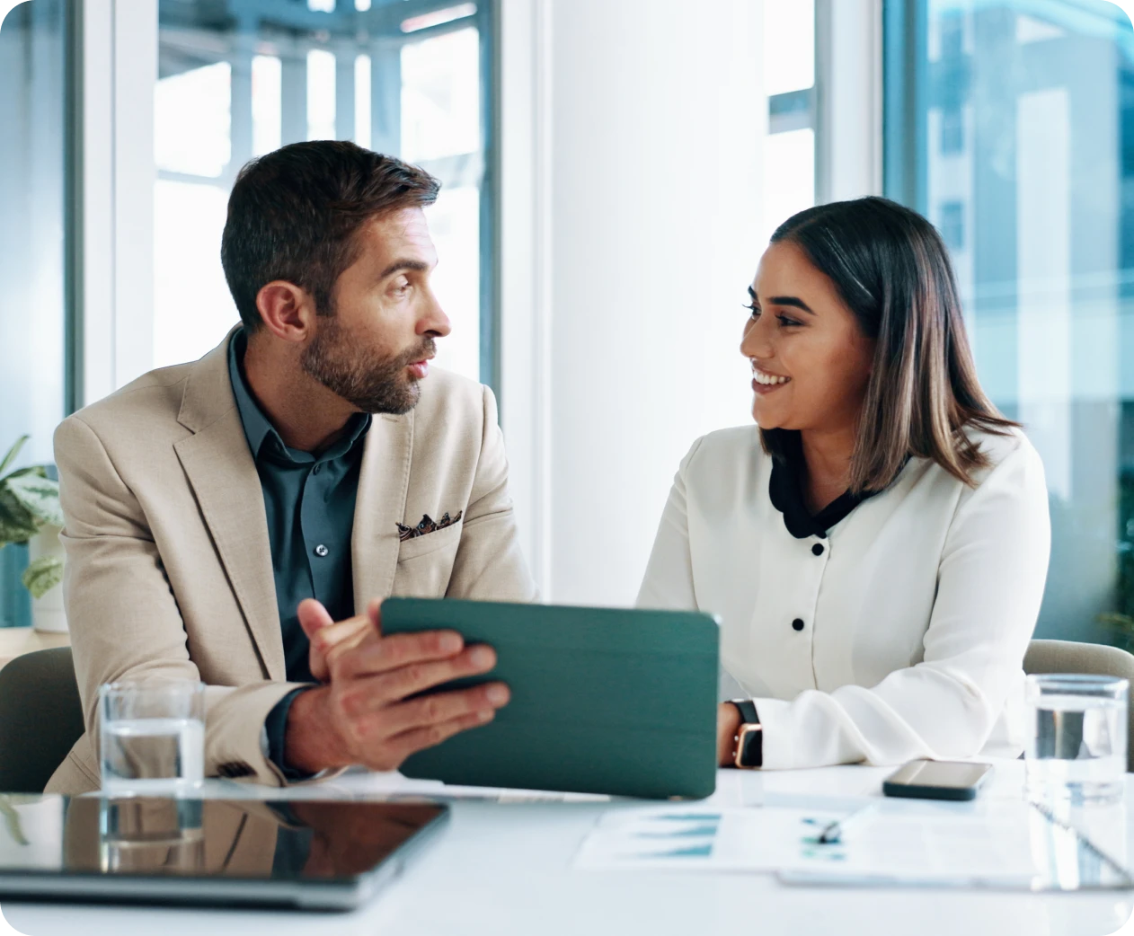 Colleagues conversing at office table